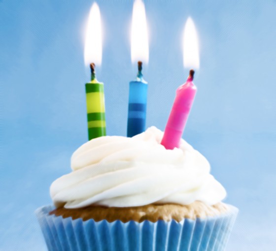 Cupcake decorated with brightly colored candles
